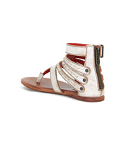 The Bed Stu Artemis II is a single metallic gladiator sandal featuring multiple leather straps, a heel zipper, and a flat brown sole, shown from the back.