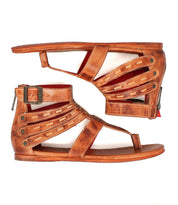 The Bed Stu Artemis II is a pair of brown leather gladiator sandals with leather straps, buckle and zipper closures, shown from the side and sole.