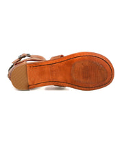 Bottom view of the Bed Stu Artemis II thong sandal, showcasing leather straps and a brown sole with a ridged grip pattern and smooth heel section.