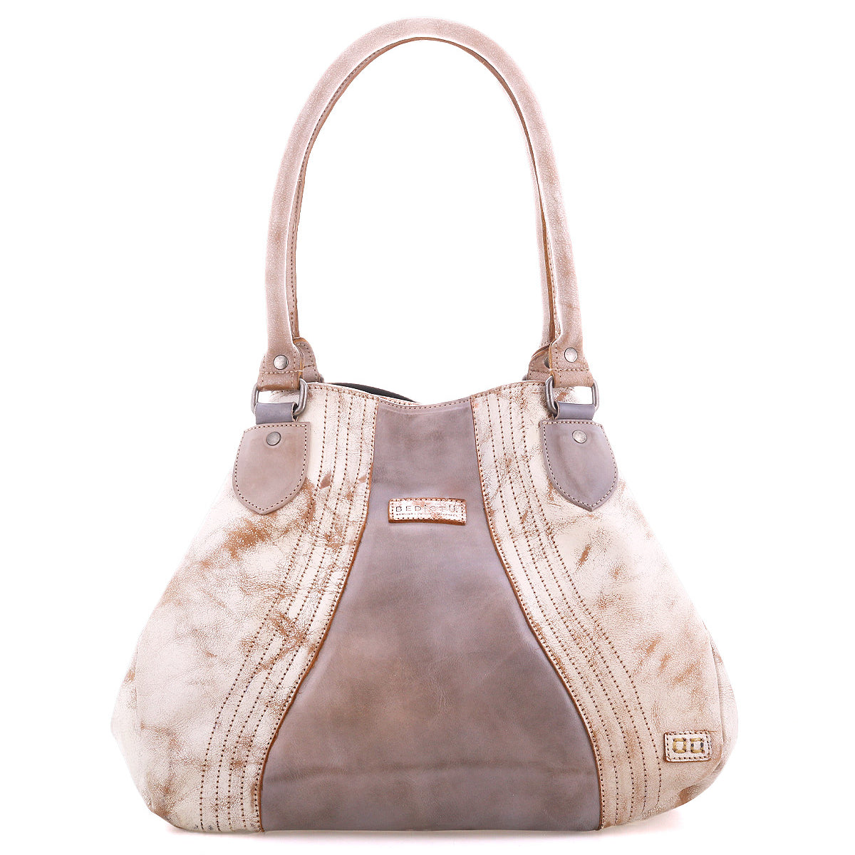 The Bed Stu Astana is a modern beige and taupe handbag featuring two handles, decorative stitching, and a metallic logo on the lower right corner, displayed against a white background.