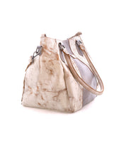 The Bed Stu Astana is a modern handbag in beige and light brown distressed leather with metal rings and dual handles, shown on a white background.