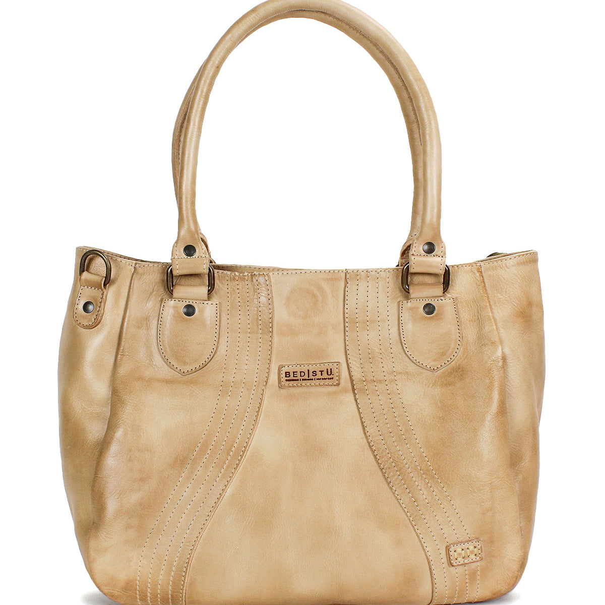 The Astana by Bed Stu is a beige leather everyday bag featuring two handles, decorative stitching, and a small rectangular brand patch on the front—a modern handbag ideal for daily use.