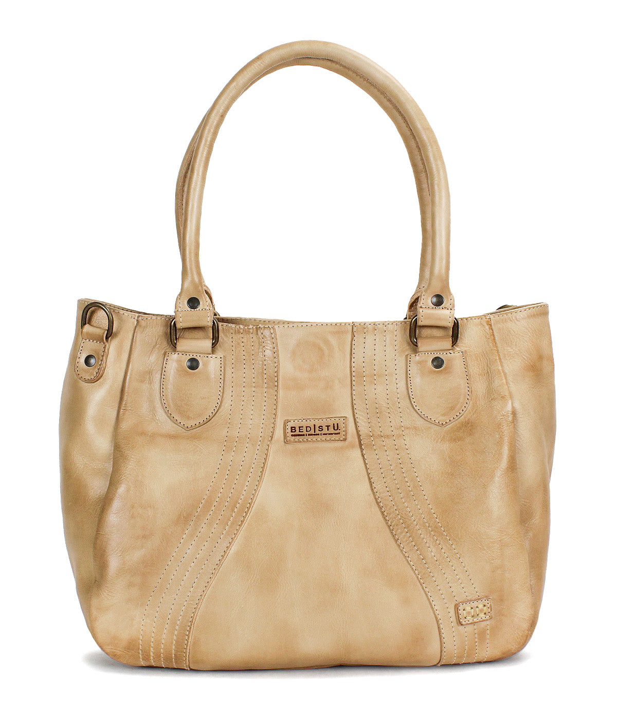 The Astana by Bed Stu is a beige leather everyday bag featuring two handles, decorative stitching, and a small rectangular brand patch on the front—a modern handbag ideal for daily use.