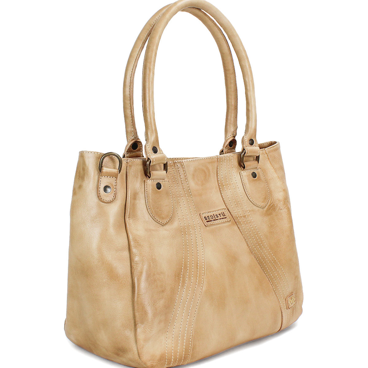 The Bed Stu Astana is a tan leather handbag featuring double handles, decorative stitching, and a small rectangular logo patch on the front—an ideal everyday bag for modern, effortless style.