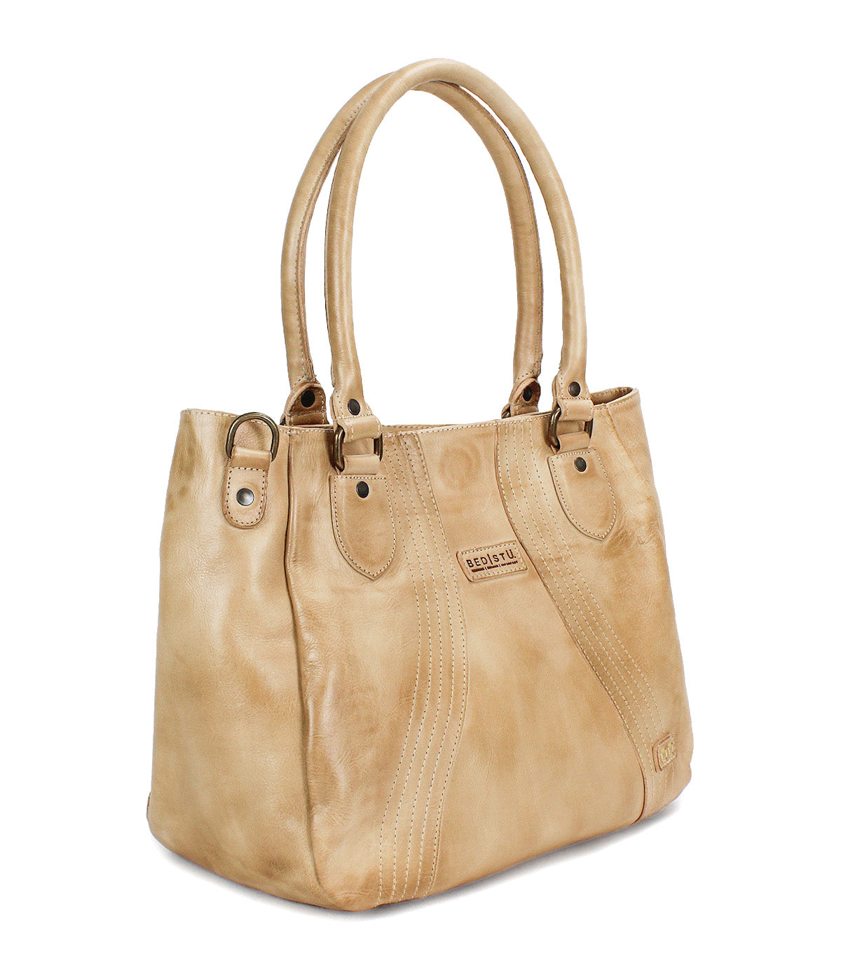 The Bed Stu Astana is a tan leather handbag featuring double handles, decorative stitching, and a small rectangular logo patch on the front—an ideal everyday bag for modern, effortless style.