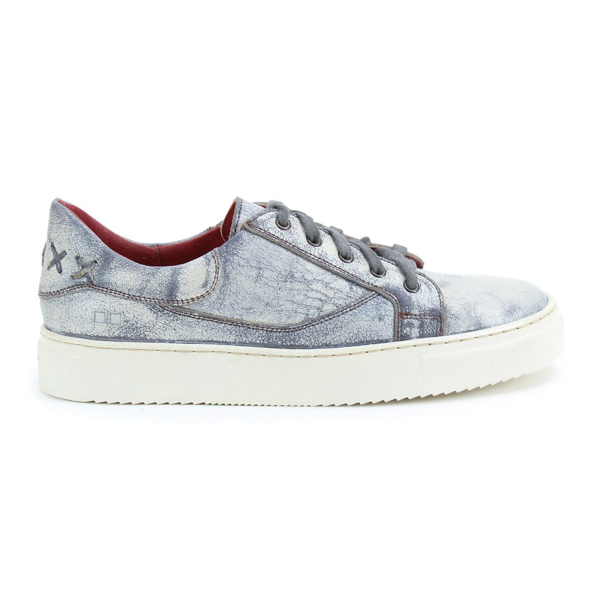 The Azeli by Bed Stu is a distressed light blue leather sneaker with a white sole and black laces, highlighted by a stitched 'X' design near the heel for a hint of classic style.