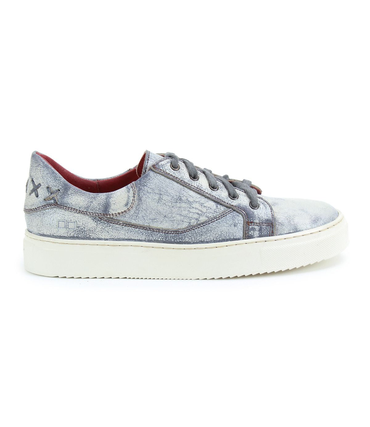 The Azeli by Bed Stu is a distressed light blue leather sneaker with a white sole and black laces, highlighted by a stitched 'X' design near the heel for a hint of classic style.