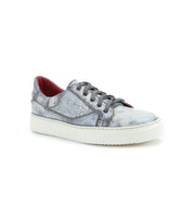 The Azeli by Bed Stu is a classic low-profile sneaker designed with gray leather for a modern appeal, featuring a distressed look, white sole, and striking red interior lining.