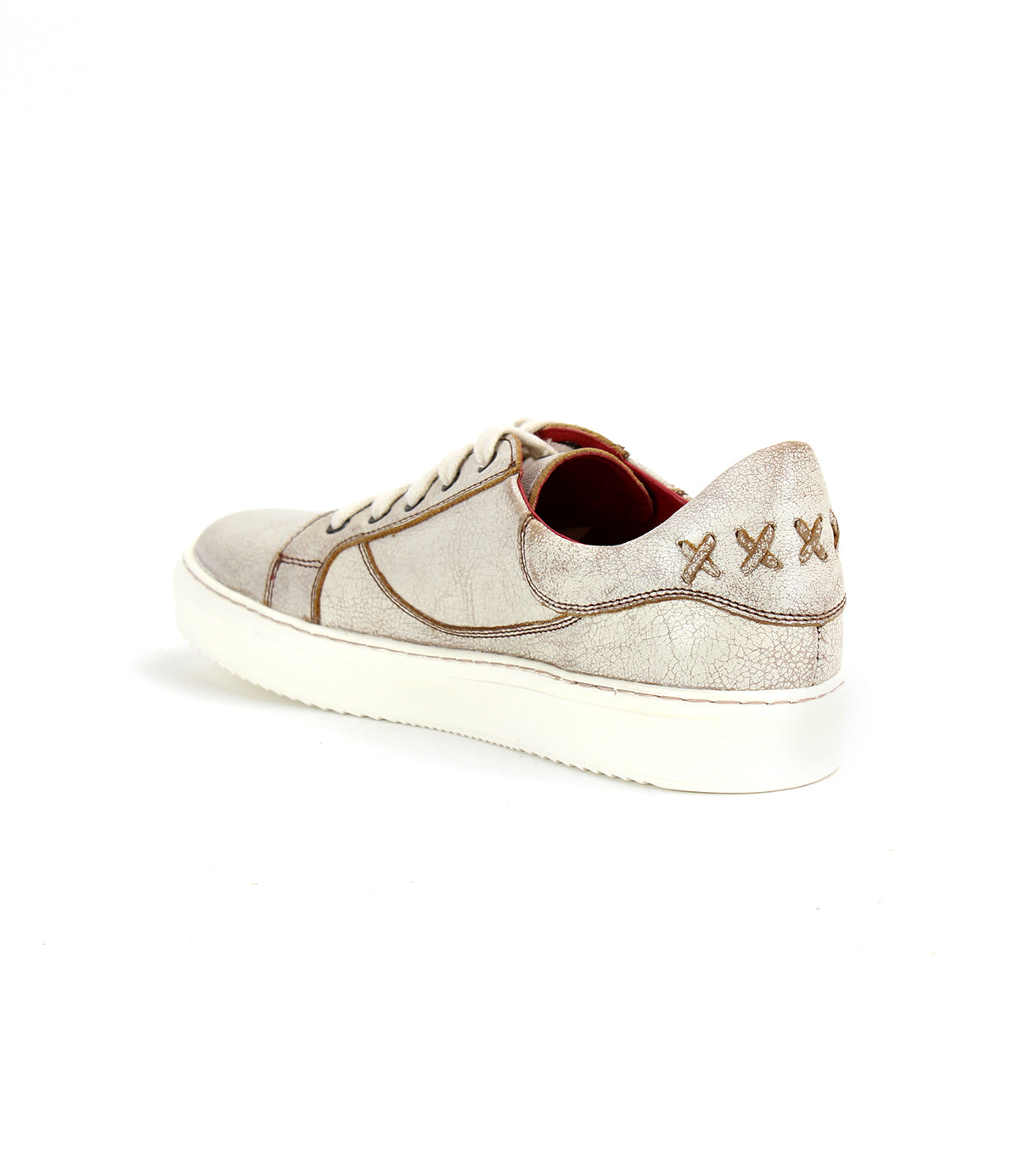 A white Azeli sneaker with gold stitching, produced by Bed Stu.