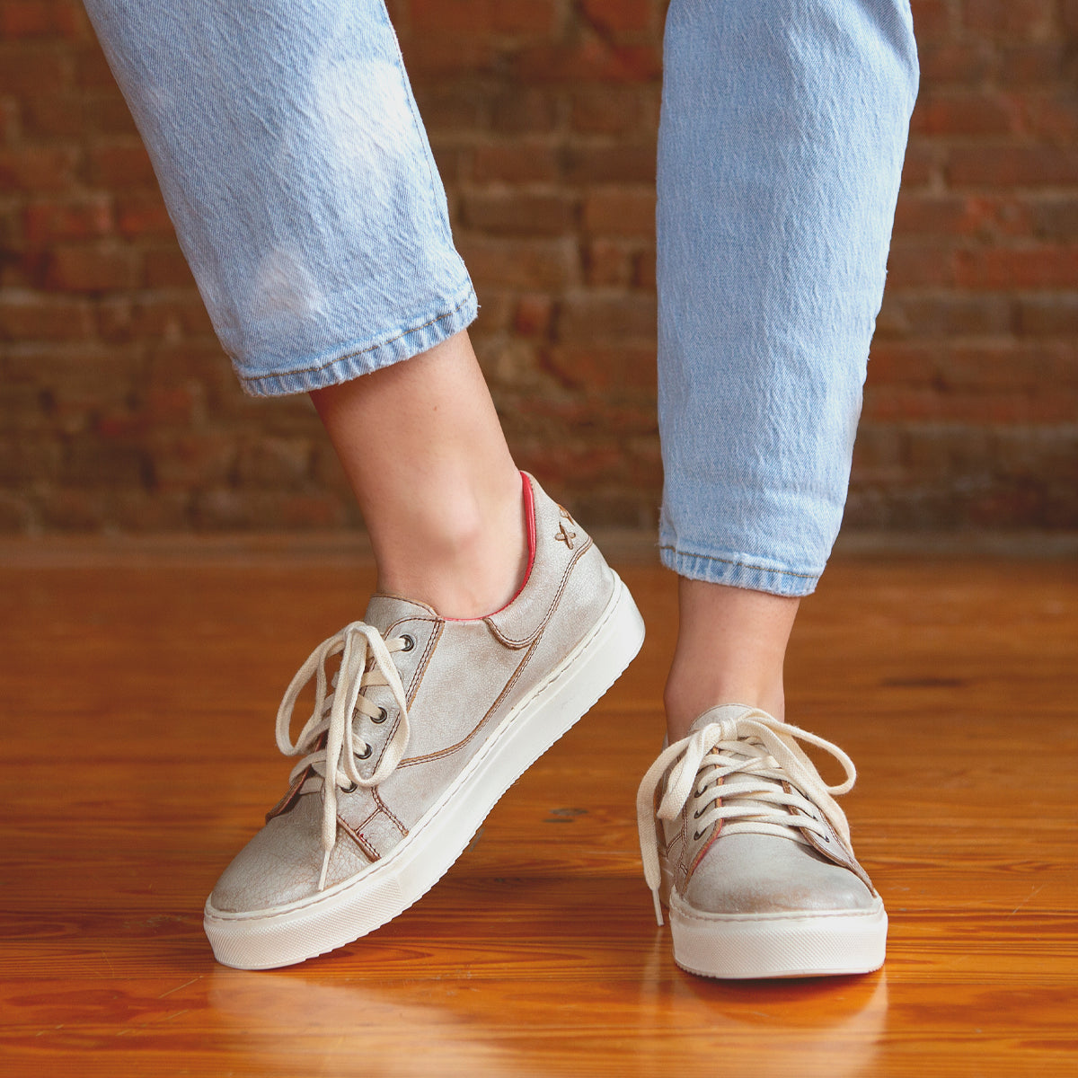 A person's legs and feet showcasing the stylish comfort of Bed Stu sneakers, Azeli.