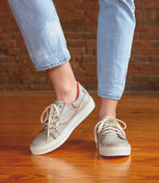 A person's legs and feet showcasing the stylish comfort of Bed Stu sneakers, Azeli.