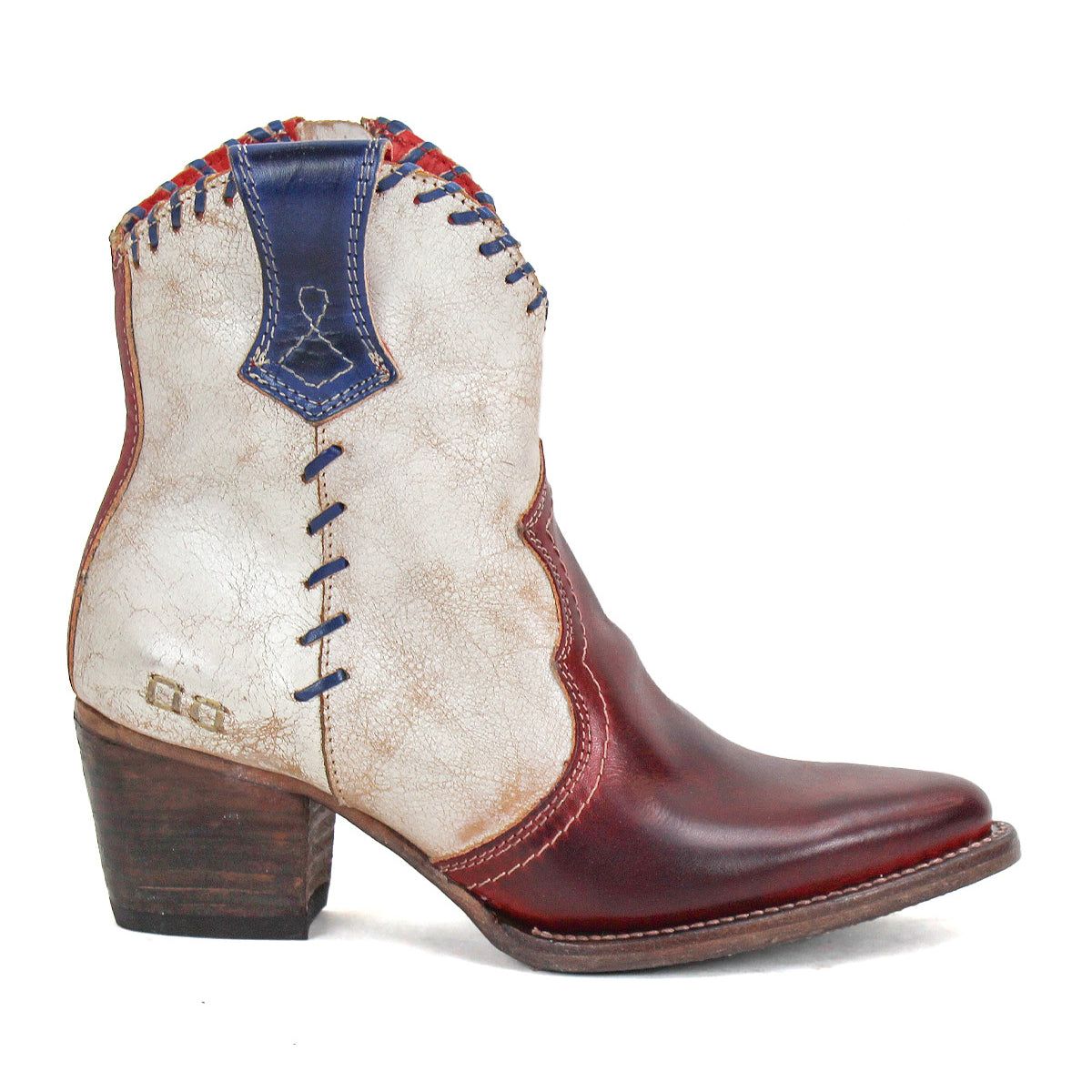 The Baila II by Bed Stu is a western-inspired ankle boot featuring a red pointed toe, distressed white upper, blue stitching, artisanal craftsmanship, and a stacked wooden heel.