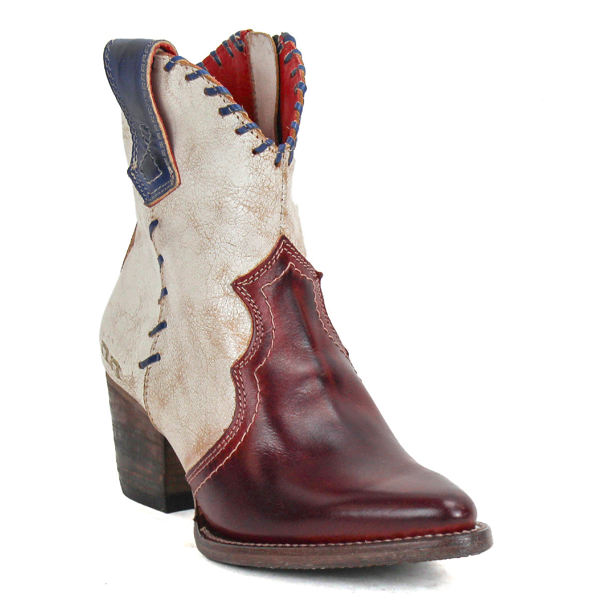 The Bed Stu Baila II is a Western-inspired women's cowboy boot featuring a maroon pointed toe and heel, cream shaft, blue accents, decorative stitching, medium stacked heel, and artisanal craftsmanship.