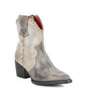 The Bed Stu Baila II is a gray leather Western boot with artisanal construction, decorative stitching, a pointed toe, and a chunky stacked heel, displayed on a white background.