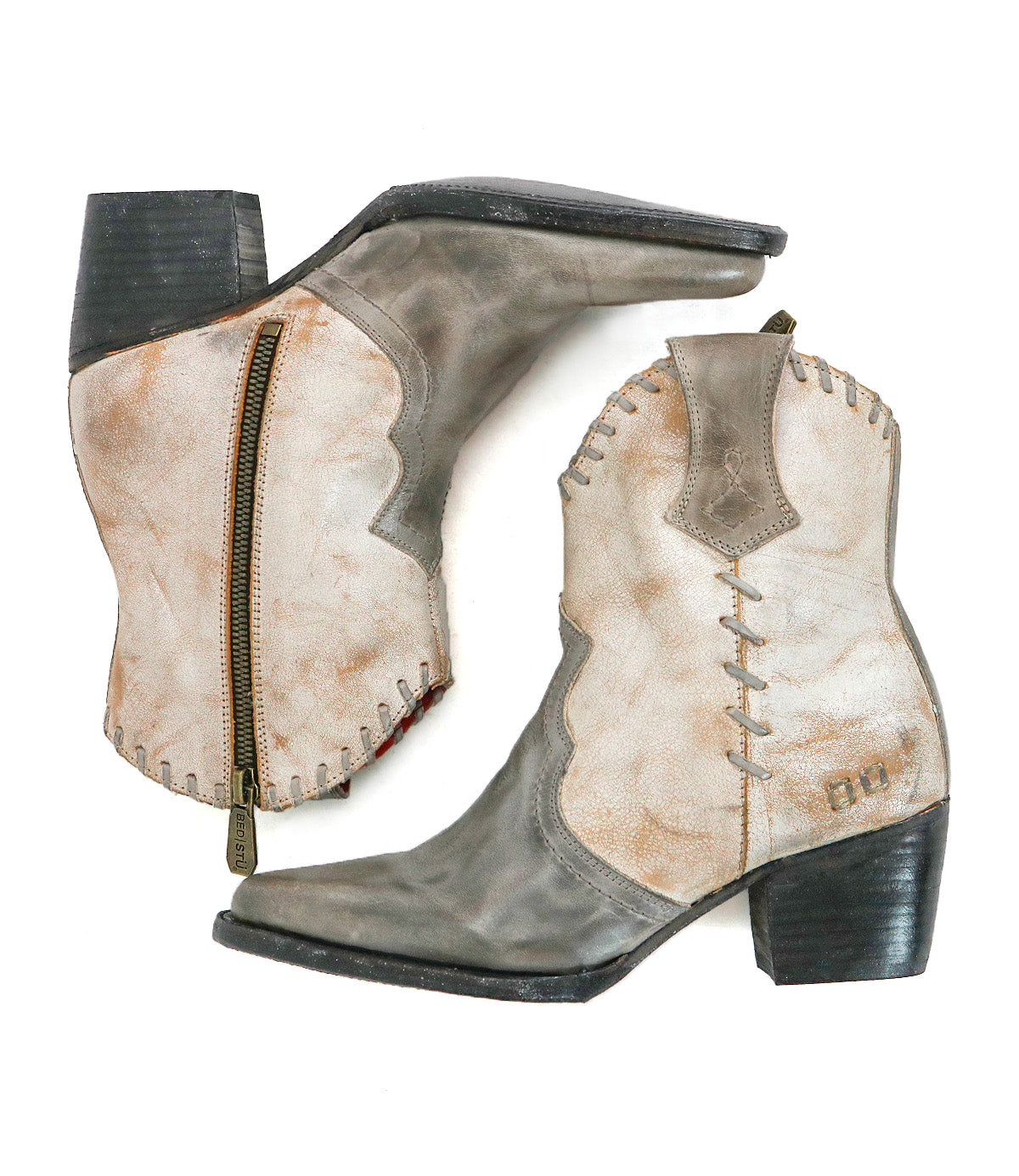 The Baila II by Bed Stu: worn tan and gray Western boots with black heels, a visible zipper on one boot, decorative stitching, and artisanal construction, shown from the side and top.