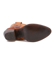 Bottom view of the Bed|Stü Baila II, a tan leather ankle boot with a pointed toe, stacked heel, and dark brown leather sole.