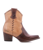 The Baila II by Bed|Stü is a two-tone brown leather cowboy boot with artisanal construction, featuring decorative stitching, a wooden heel, and a pointed toe. This Western-inspired boot is shown in a side view against a white background.