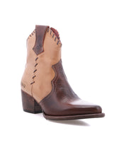 The Baila II by Bed|Stü is a brown and tan leather ankle cowboy boot featuring decorative stitching, a low stacked heel, and a pointed toe. Artisanal construction highlights its classic Western-inspired style, as photographed against a white background.