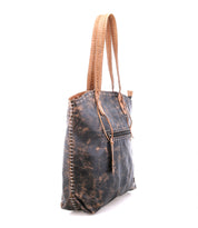 The Bed Stu Barra II is a distressed brown leather decorative tote bag with tan stitched handles, white woven side stitching, and an organic cotton lining, shown against a white background.