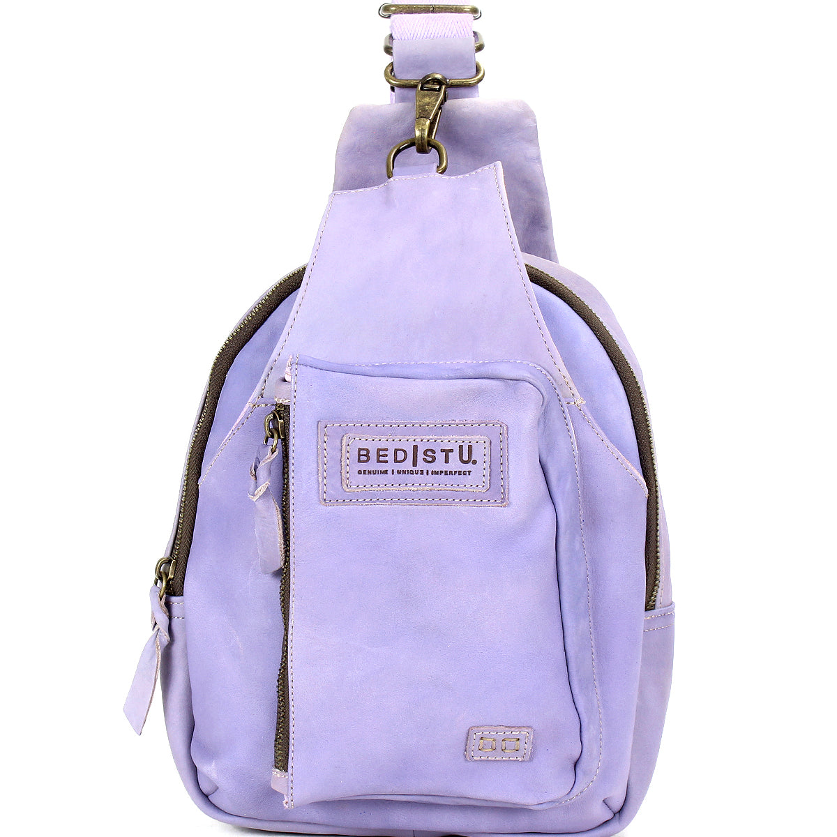 The Beau by Bed Stu is a small lavender leather sling backpack with a durable strap, front zipper pocket, main compartment, and a "BED|STU" patch label—ideal for hands-free activities.