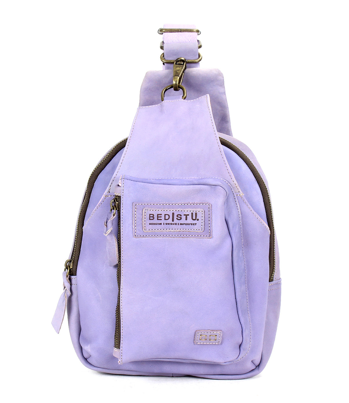 The Beau by Bed Stu is a small lavender leather sling backpack with a durable strap, front zipper pocket, main compartment, and a &quot;BED|STU&quot; patch label—ideal for hands-free activities.