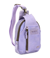 The Beau by Bed Stu is a small lavender leather sling backpack featuring a front zipper pocket, large side zip, durable adjustable strap, and visible "Bed Stu" branding on the front—ideal for hands-free activities.