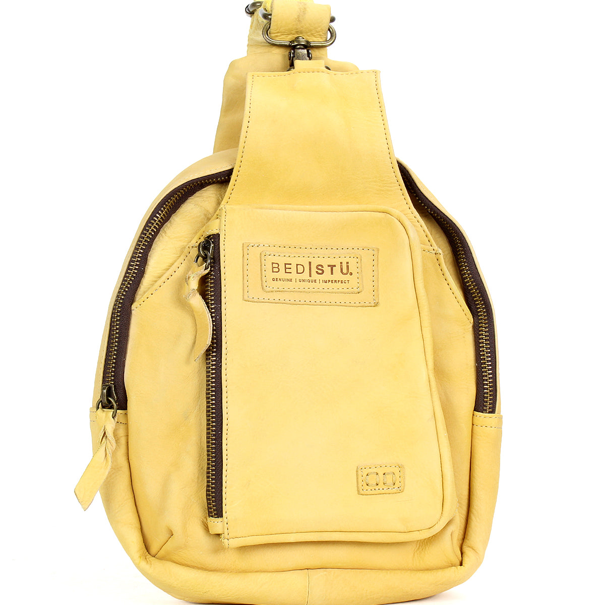 The Beau by Bed Stu is a yellow leather sling backpack with a front zipper pocket, logo patch, and sturdy strap—ideal for hands-free outings.