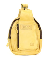 The Beau by Bed Stu is a yellow leather sling backpack with a front zipper pocket, logo patch, and sturdy strap—ideal for hands-free outings.