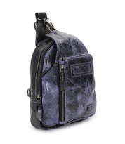 The Bed Stu Beau is a small black and purple leather sling backpack featuring a front zipper pocket and top handle, combining hands-free convenience with stylish storage for your daily essentials.