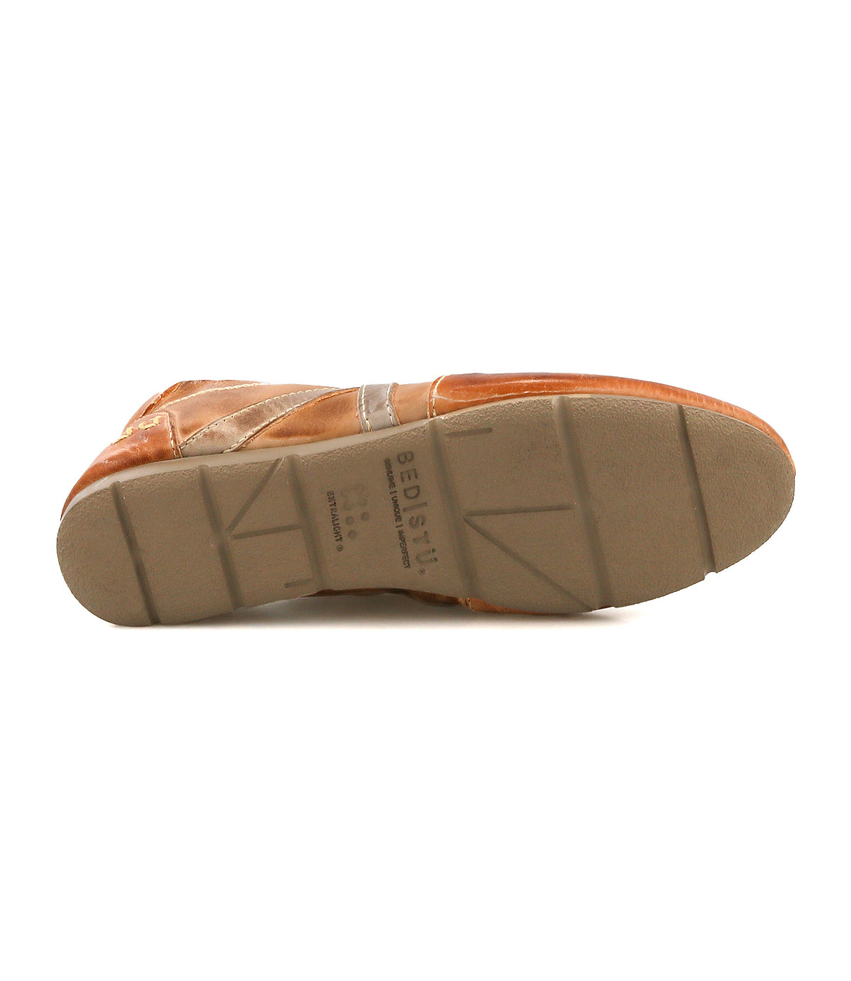 The Bed Stu Bingo II brown leather sneaker is shown with its sole facing up, highlighting the tread patterns and imprinted text on its XL EXTRALIGHT outsole.