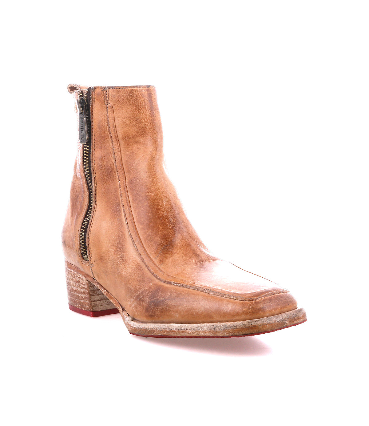 The Bed Stu Bitsy is a tan leather ankle boot with a side zipper, stacked wooden heel, and lightly worn sole, shown against a white background.