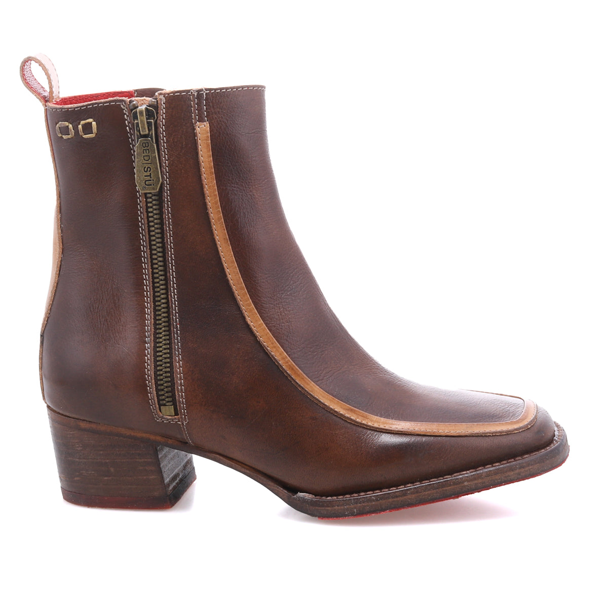 The Bed Stu Bitsy is a brown leather ankle boot with tan trim, side zipper, low stacked heel, square toe design, and a back pull tab.