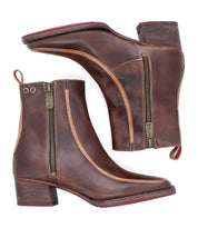 The Bed Stu Bitsy is a pair of brown leather ankle boots with side zippers, stacked heels, pull tabs, and square toes. Shown from the side and sole view, these boots combine style and comfort for any occasion.