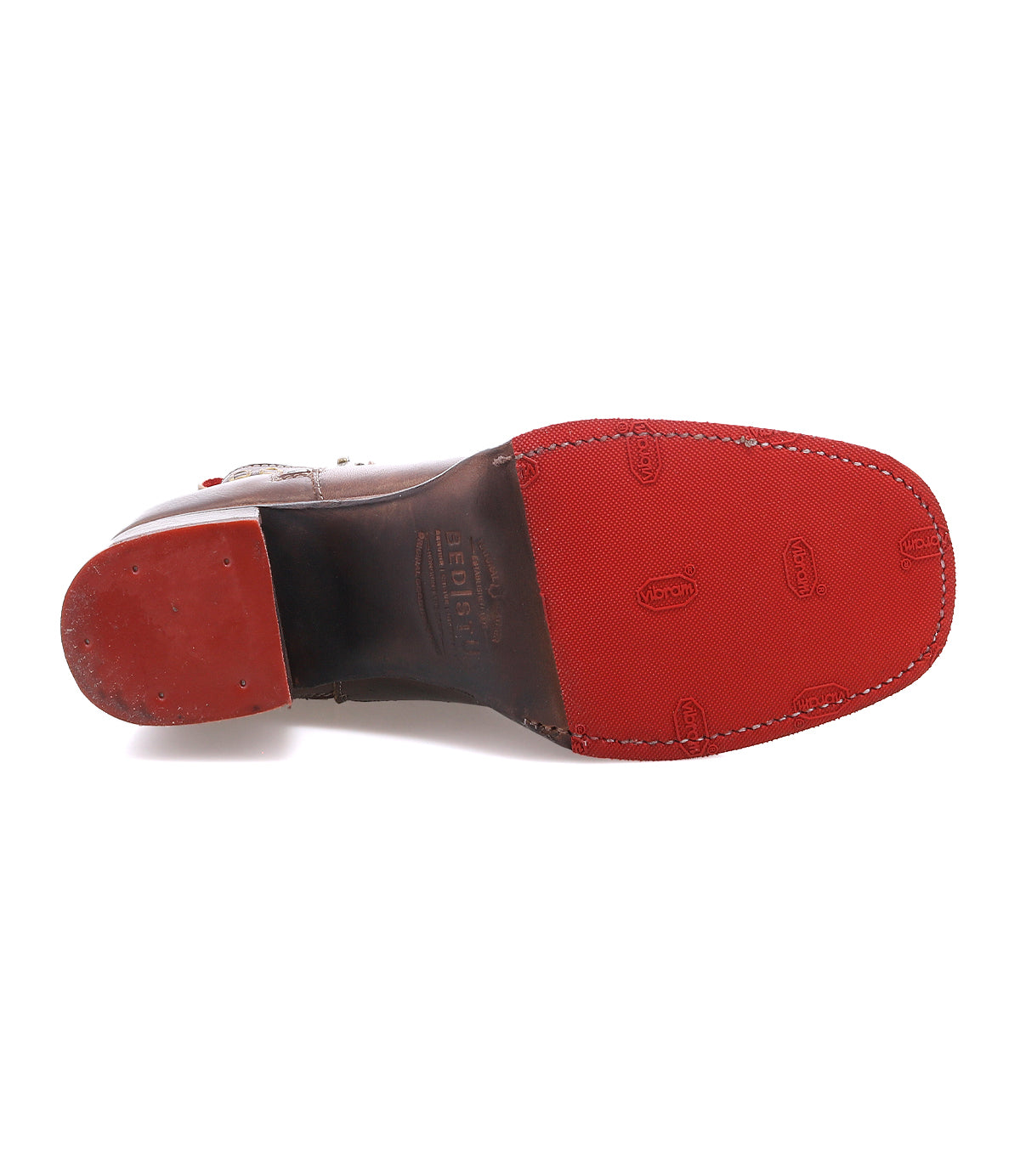Bottom view of the Bed Stu Bitsy brown leather dress shoe features a red Vibram rubber sole, stacked heel, visible branding, and textured grip pattern.