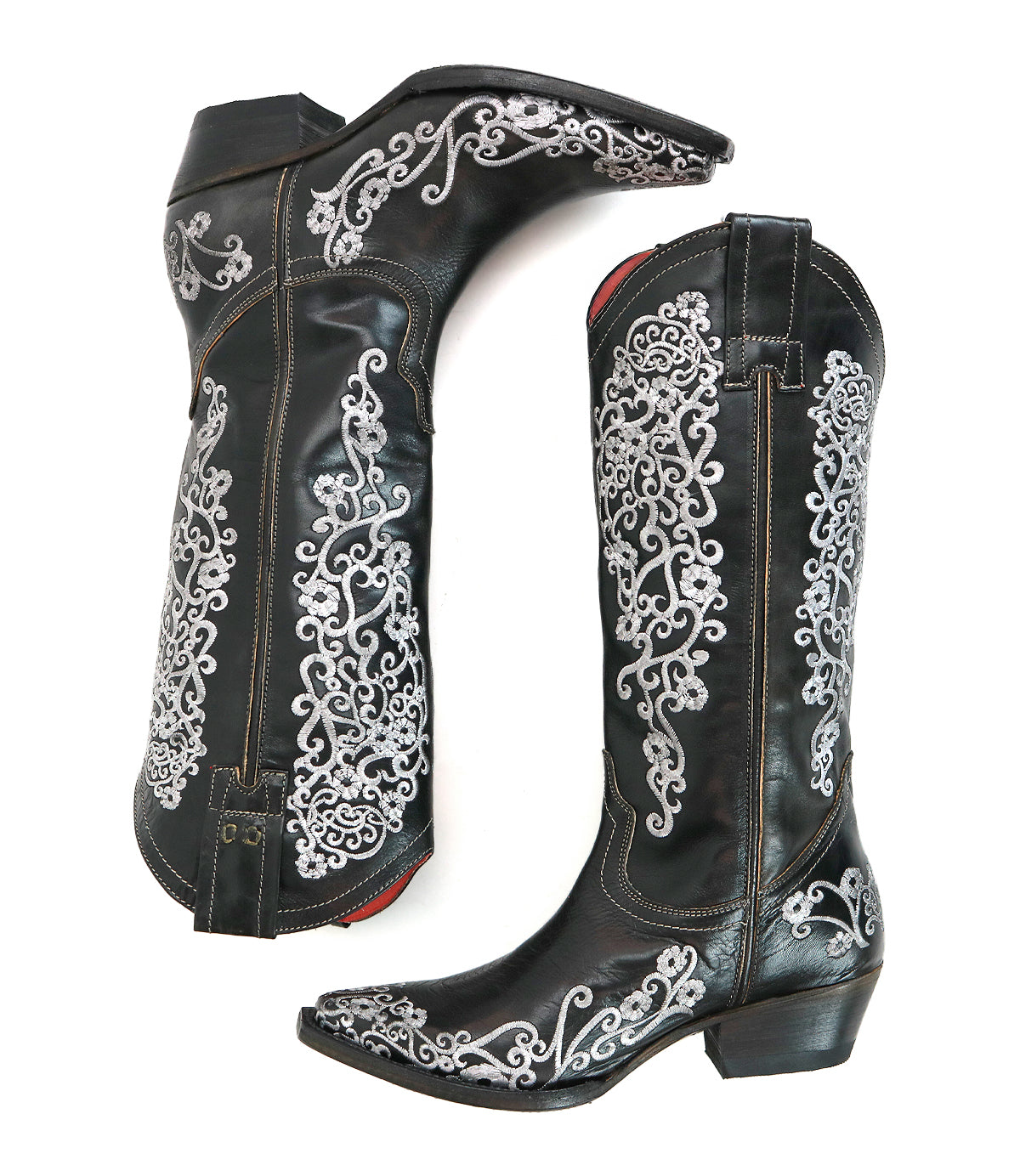 Black cowboy boots with white intricate patterns on a white background