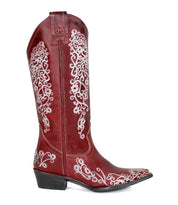 The Bed Stu Blackjack boot is a single tall, red leather Western boot with white floral embroidery and a low angled heel, shown in profile against a white background.