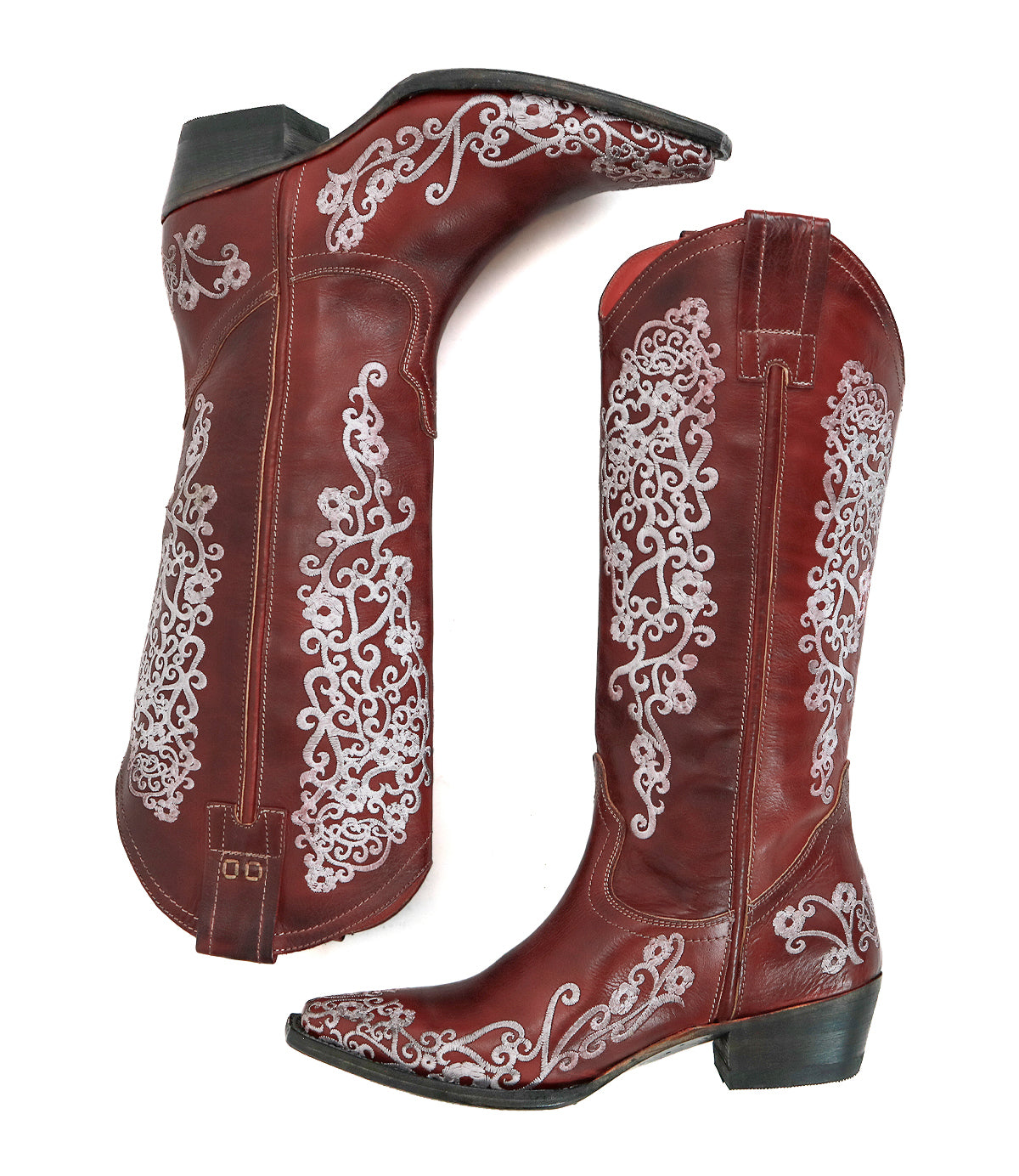 The Bed Stu Blackjack boots are red leather Western tall boots with white floral embroidery and a snip toe, shown from the side and bottom views.