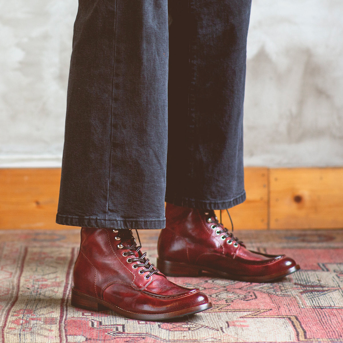 A person wearing a pair of Blimey boots by Bed Stu on a rug.