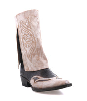 The Bed Stu Blind cowboy boot features a pointed toe, black foot, and light tan shaft with decorative stitching, showcasing a classic Western style. Photographed solo on a white background.