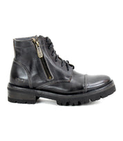 The Bed|Stü Bonnie IV is a black leather combat boot featuring dual side zippers, a lace-up front, and a rugged rubber sole, displayed in a left side profile against a white background.