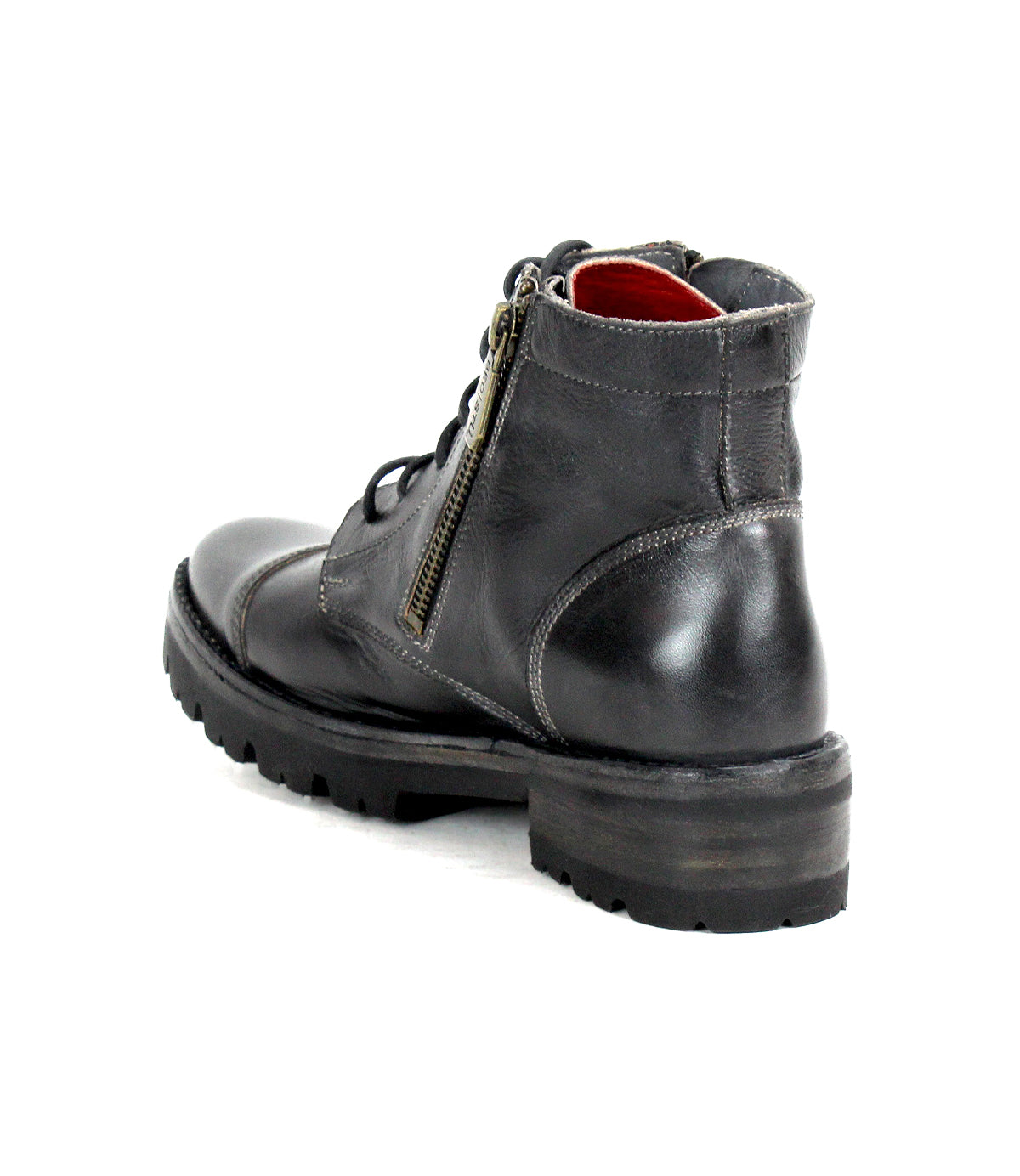 The Bed|Stü Bonnie IV is a black leather combat boot with a no-frills silhouette, visible stitching, lace-up front, dual side zippers, and a thick rubber sole, shown from the back angle on a white background.