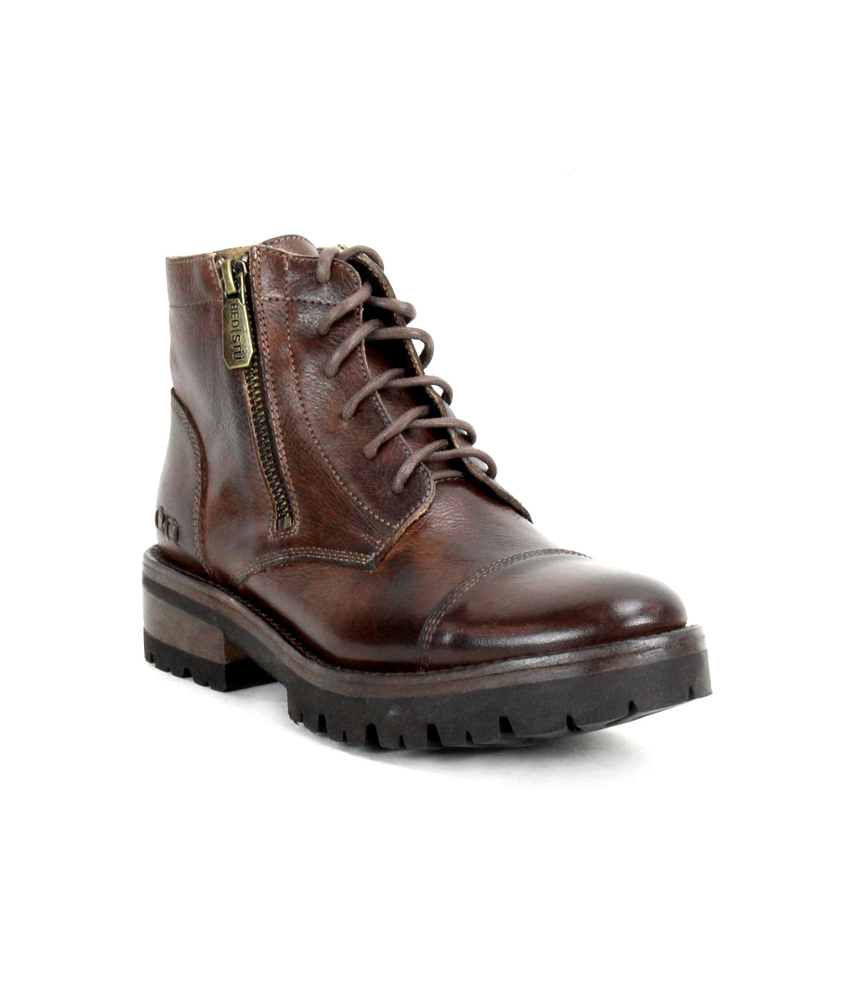 The Bed|Stü Bonnie IV is a brown leather lace-up combat boot featuring a minimalist silhouette, side zipper, rugged sole, and low heel, displayed on a white background.