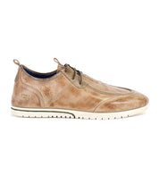 The Bed|Stü Britches is a tan chukka-style leather casual shoe featuring laces, a refined white rubber sole, and detailed stitching, shown in a left-side profile against a white background.