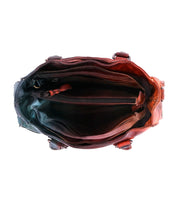 Top view of the Bed Stu Bruna leather bag, highlighting artisanal craftsmanship and multiple compartments—including a central zippered pocket and side pockets—set against a white background.