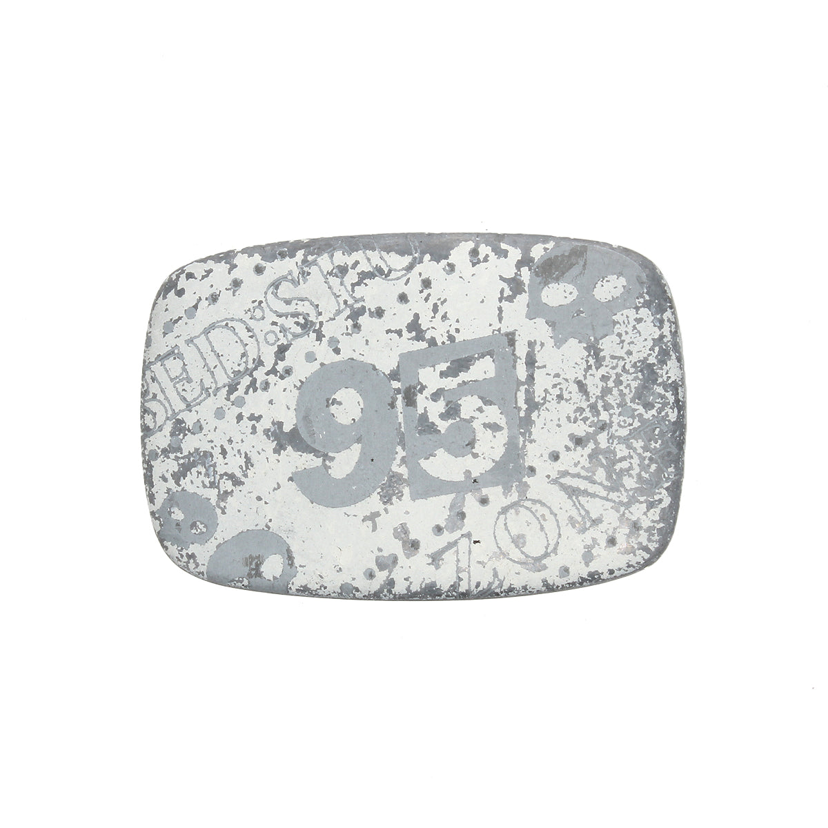 The Bed Stu 95 Buckle is a rectangular, weathered metal plate with a rugged look, featuring the faded number "95" and other markings on a white background.