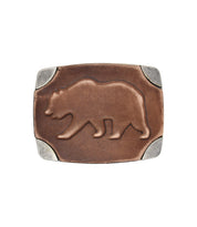The Bed Stu Bear Buckle is a rectangular brown leather western belt buckle, featuring a raised bear design and metal corners.