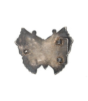 Back view of the Bed Stu Butterfly Bead Buckle, featuring a metal butterfly shape with a pin and clasp mechanism, showcased on a plain white background.