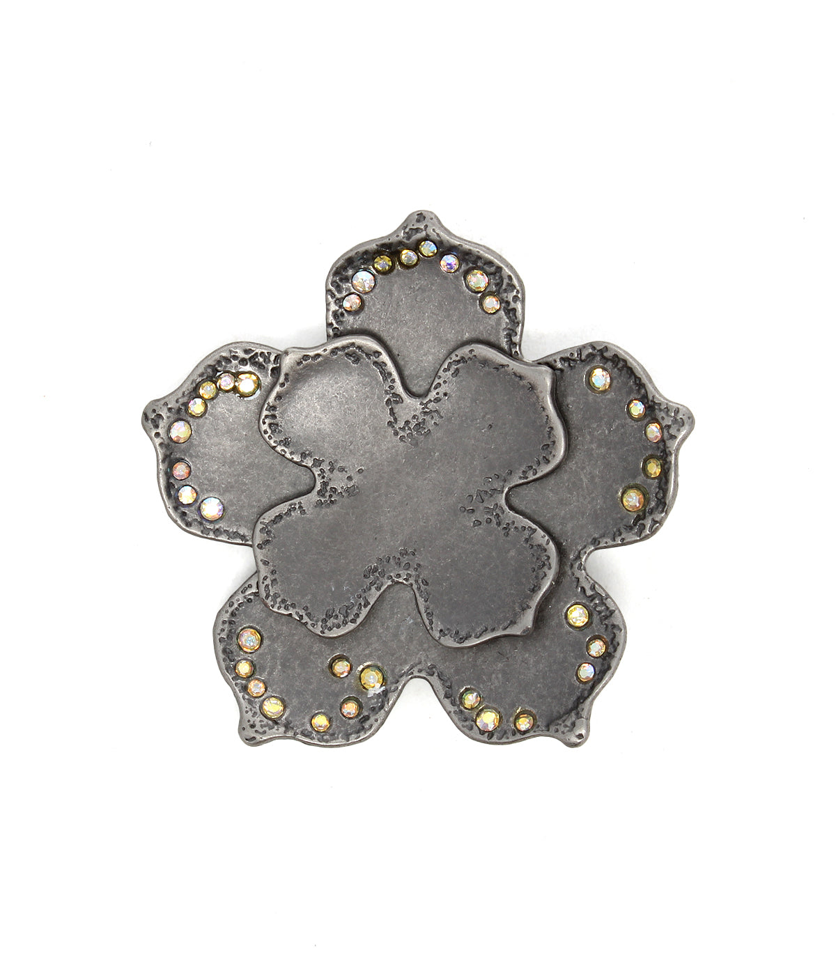 The Bed Stu Flower Sparkle Buckle features a metal, flower-shaped design with textured petals and small round gemstones along the edges, giving it a vintage-inspired look.
