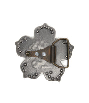 The Bed Stu Flower Sparkle Buckle is a vintage silver belt buckle with a flower-shaped base, textured surface, and secure prong and loop fastening on the back.