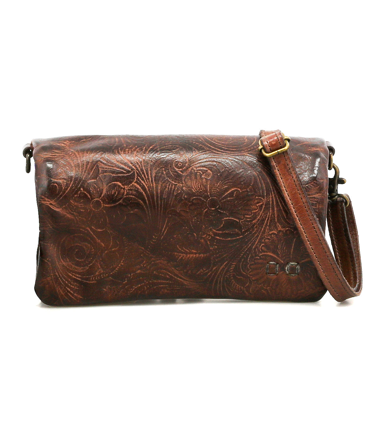 The Bed Stu Cadence EM is a brown leather clutch bag with an adjustable strap and embossed floral pattern, shown against a white background.